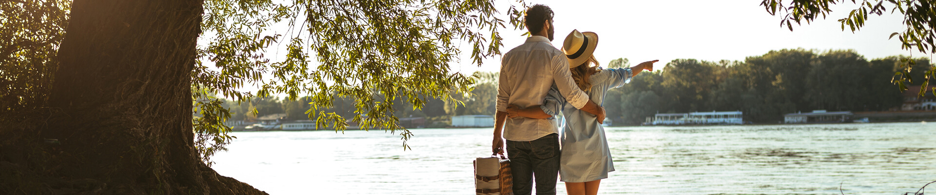 Couple standing next to a lake